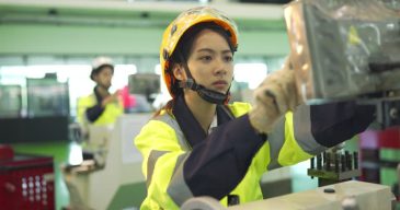 gettyimages-1501050596-640x640 4K Female Mechanical Engineer Using Machine In A Factory While Her Colleagues Working In The Background